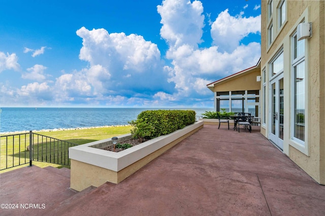 view of patio with a water view