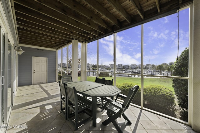 sunroom with wood ceiling and a healthy amount of sunlight