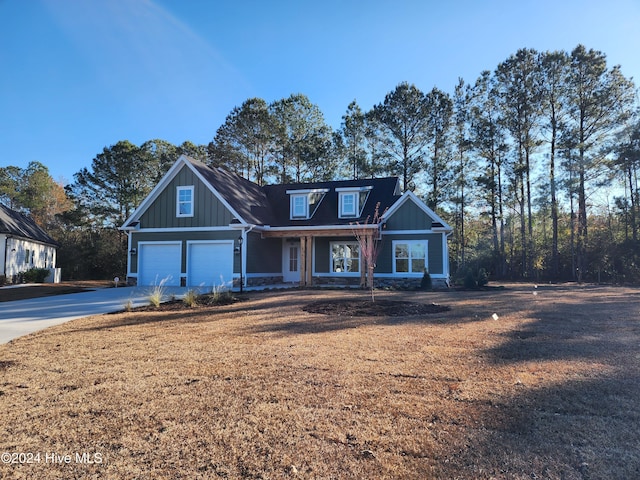 craftsman house with a front lawn and a garage