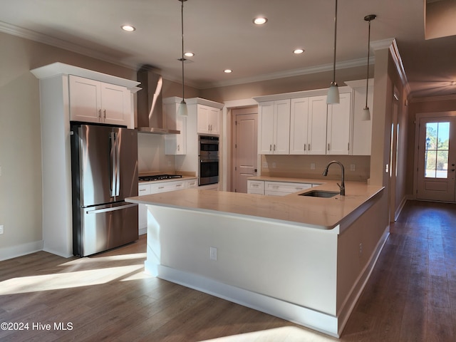 kitchen with white cabinets, hanging light fixtures, wall chimney exhaust hood, and stainless steel appliances