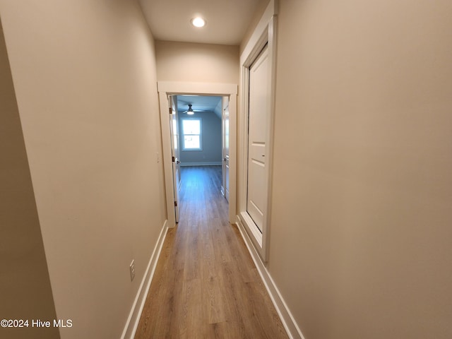 hallway with light hardwood / wood-style floors