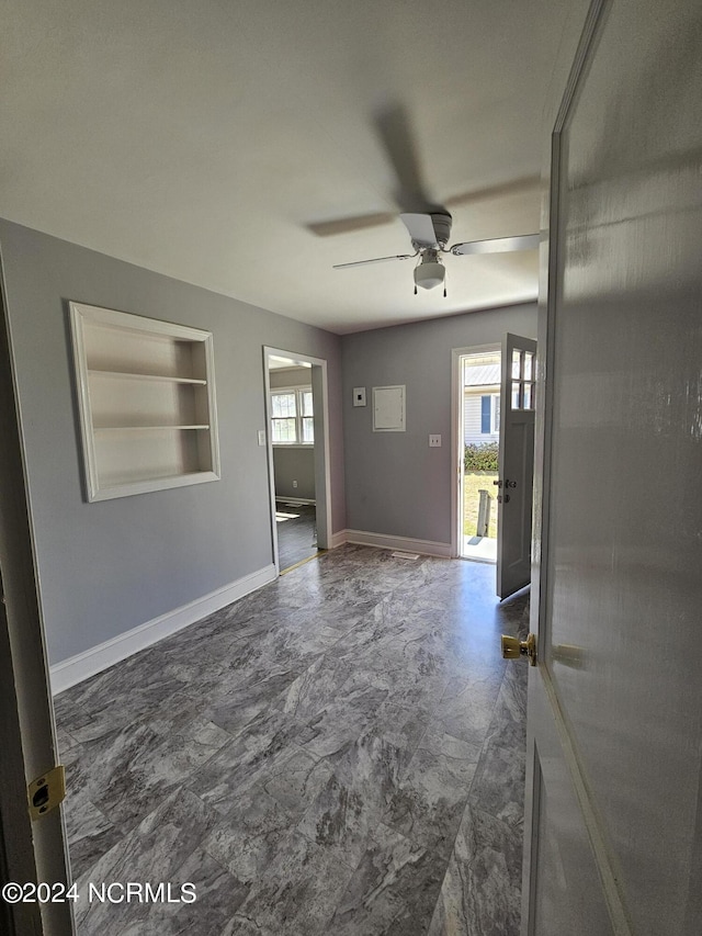 interior space featuring ceiling fan and a healthy amount of sunlight