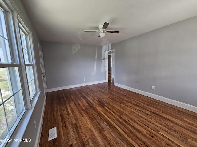 spare room with ceiling fan and dark wood-type flooring