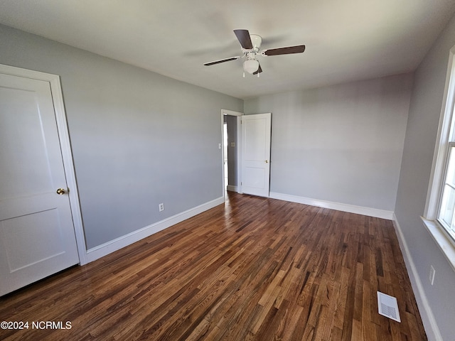 unfurnished bedroom featuring dark wood-type flooring and ceiling fan