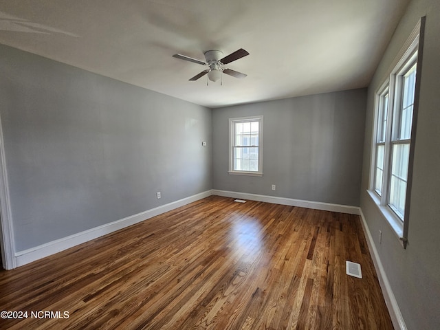 unfurnished room with hardwood / wood-style flooring and ceiling fan