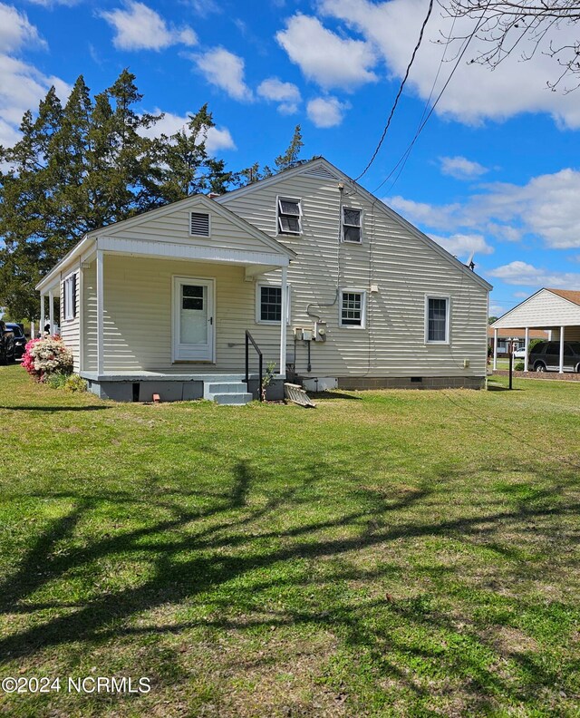 back of house with a yard