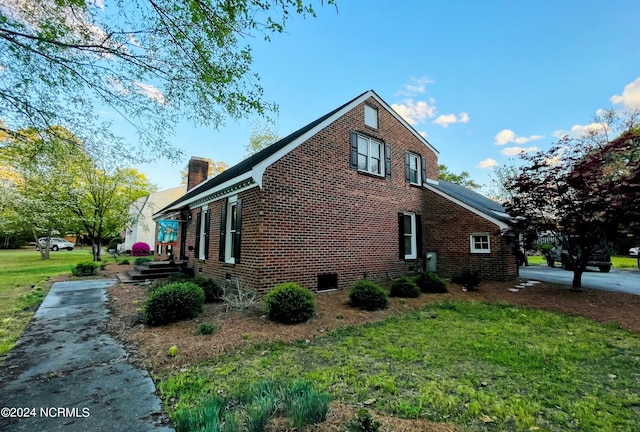 view of property exterior featuring a lawn