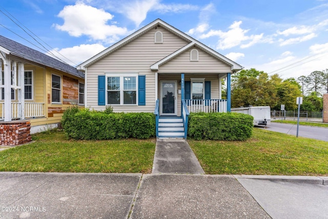 bungalow-style home featuring a front lawn and a porch