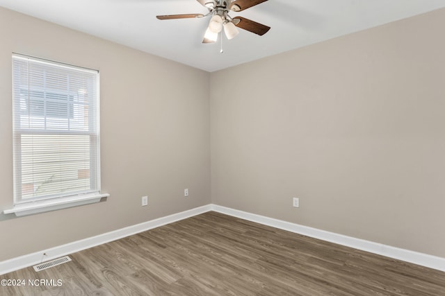 unfurnished room with ceiling fan and dark hardwood / wood-style flooring