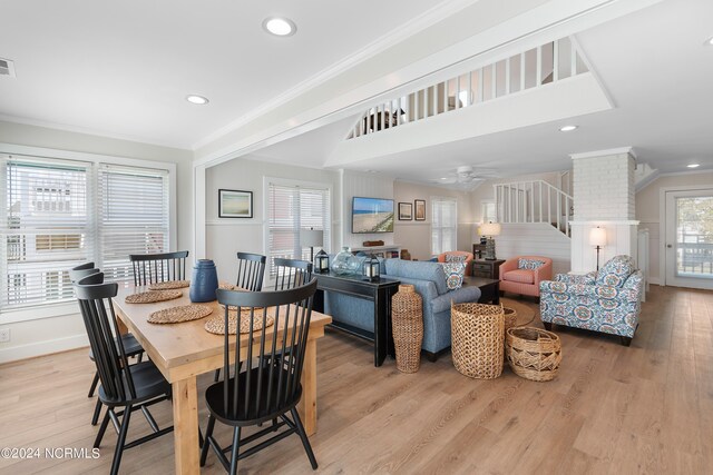 dining area featuring ceiling fan, wood-type flooring, and ornamental molding