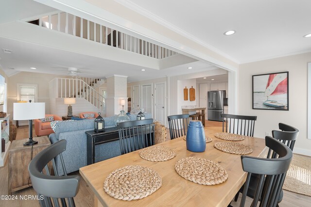 dining room featuring hardwood / wood-style floors, ceiling fan, and crown molding