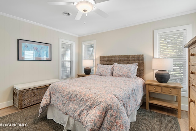 bedroom featuring baseboards, wood finished floors, a ceiling fan, and crown molding