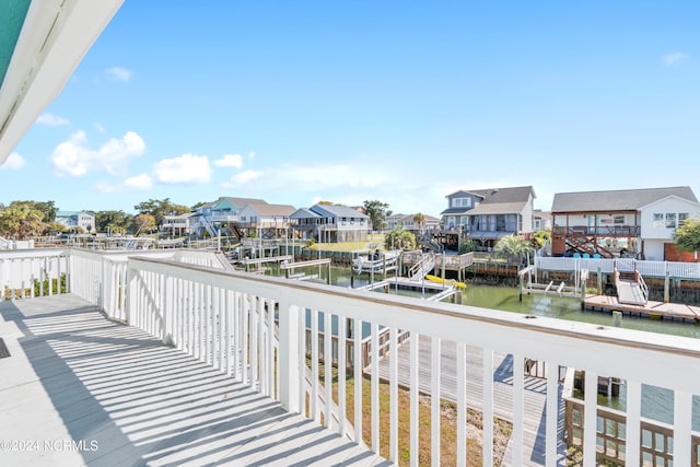 balcony featuring a water view and a dock