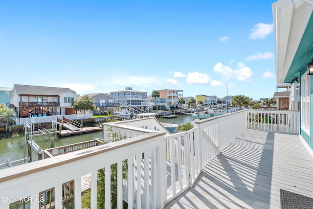 balcony featuring a water view and a residential view