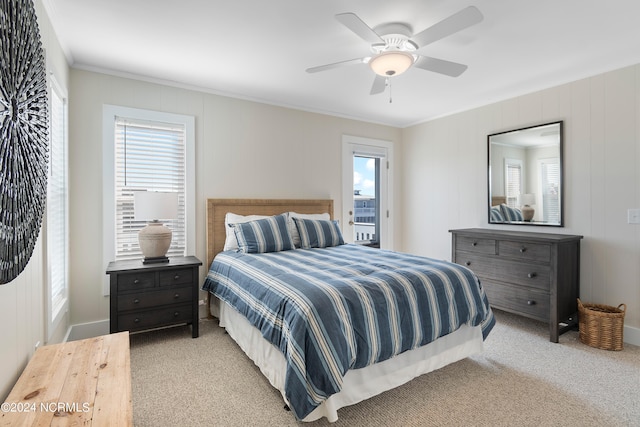 carpeted bedroom featuring ceiling fan and crown molding