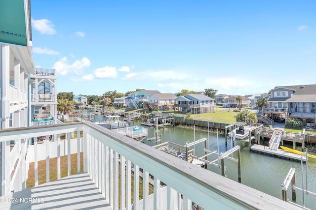 balcony with a boat dock and a water view