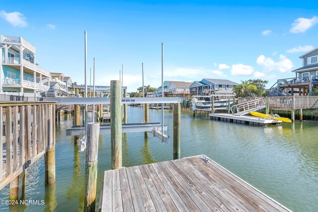 dock area featuring a balcony and a water view