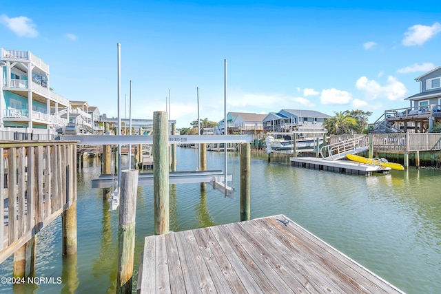 view of dock with a water view and a residential view