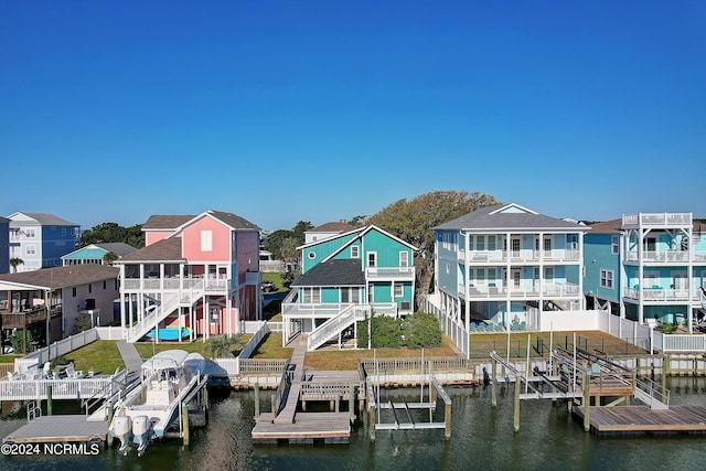 view of dock with a water view and a residential view