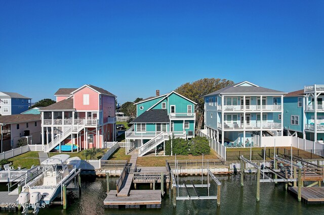 dock area with a balcony and a water view