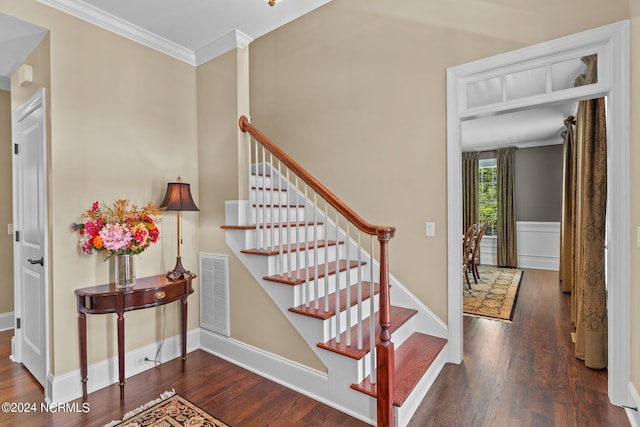 staircase with ornamental molding and hardwood / wood-style flooring