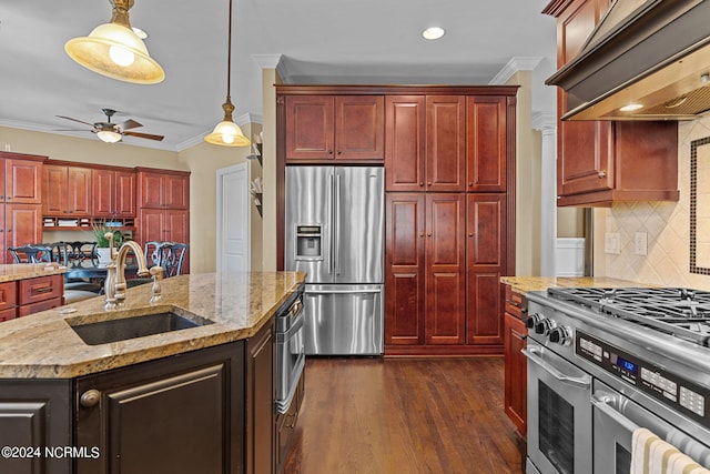 kitchen featuring sink, an island with sink, custom exhaust hood, appliances with stainless steel finishes, and dark hardwood / wood-style flooring