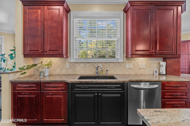 kitchen with crown molding, stainless steel dishwasher, sink, and tasteful backsplash