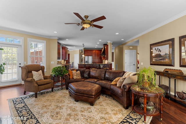 living room with ornamental molding, decorative columns, light hardwood / wood-style floors, and ceiling fan