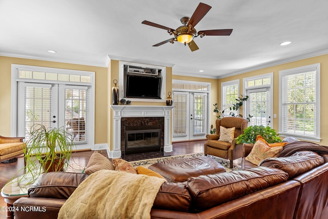 living room featuring ornamental molding, a wealth of natural light, wood-type flooring, and french doors