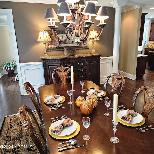 dining room featuring crown molding, dark hardwood / wood-style flooring, and ornate columns