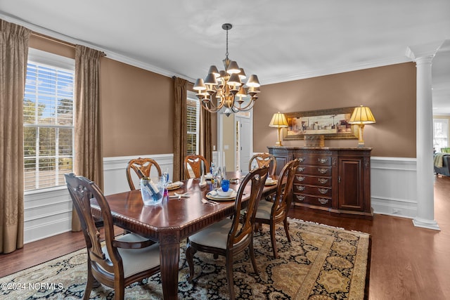 dining room featuring a wealth of natural light, dark hardwood / wood-style floors, and ornate columns