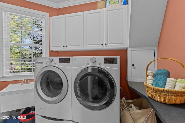 clothes washing area with separate washer and dryer, cabinets, sink, and a wealth of natural light