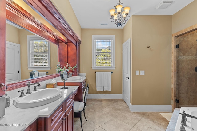 bathroom featuring an inviting chandelier, shower with separate bathtub, tile patterned flooring, and vanity