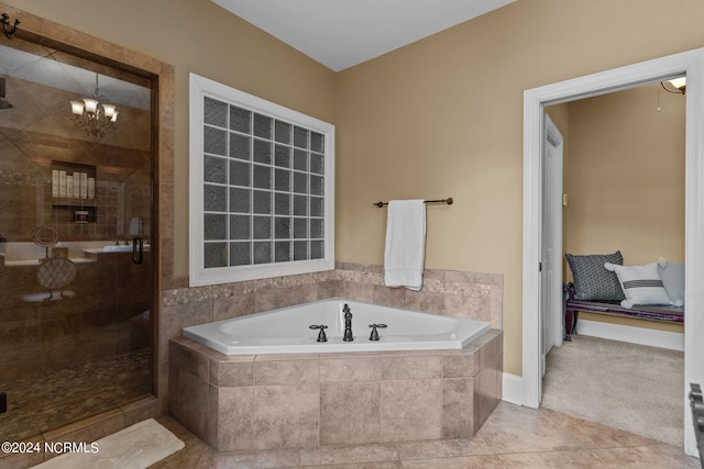 bathroom featuring tile patterned flooring, a chandelier, and plus walk in shower