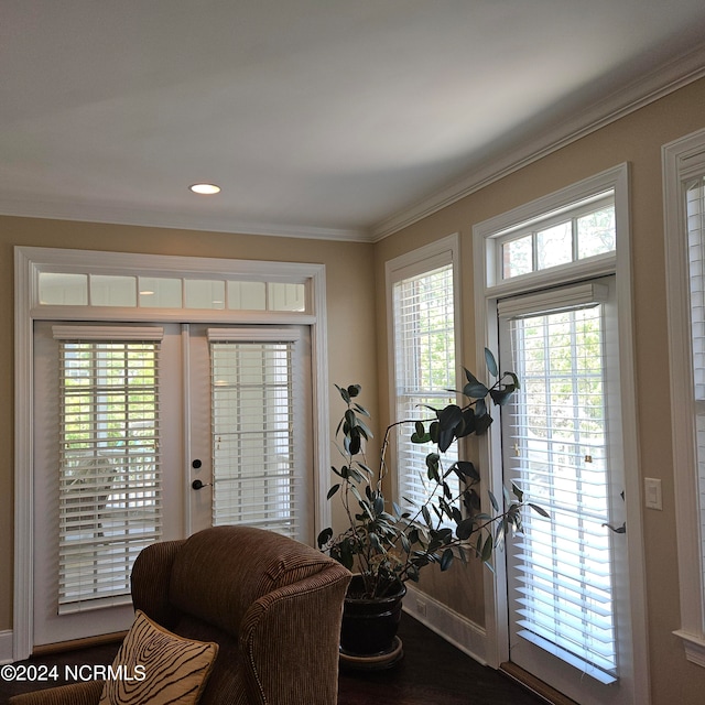 foyer entrance featuring wood-type flooring, ornamental molding, and a wealth of natural light