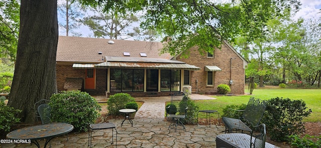 rear view of property featuring a patio area and a yard