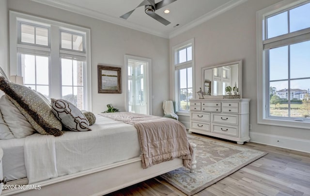 bedroom featuring light hardwood / wood-style floors, multiple windows, and ceiling fan