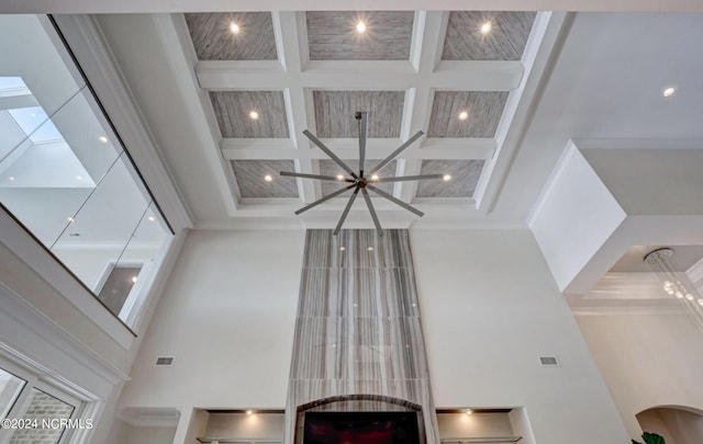 room details featuring beam ceiling, a chandelier, crown molding, and coffered ceiling