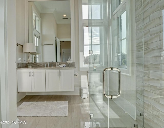 bathroom with a shower with door, oversized vanity, and tile flooring