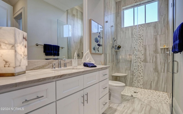 bathroom with a shower with shower door, vanity, tile floors, and toilet