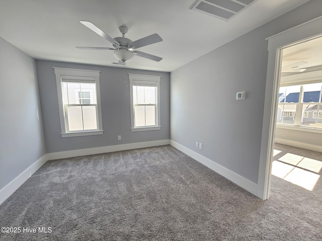 spare room featuring carpet flooring and ceiling fan