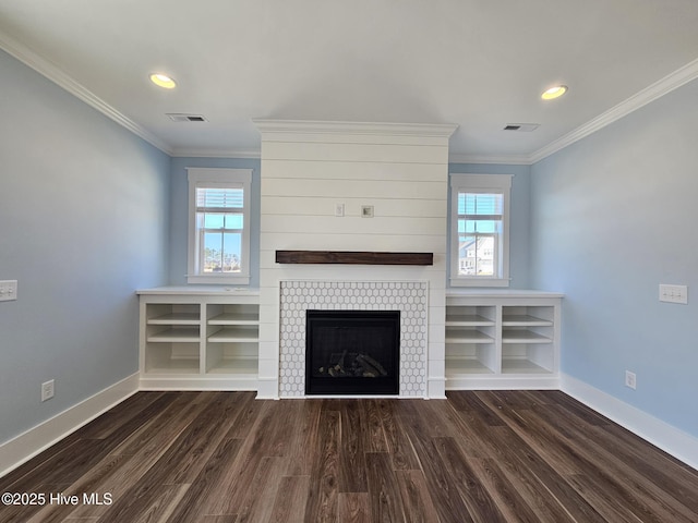 unfurnished living room with dark hardwood / wood-style flooring, ornamental molding, and a tile fireplace