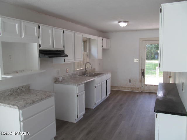 kitchen with sink, dark hardwood / wood-style floors, and white cabinetry