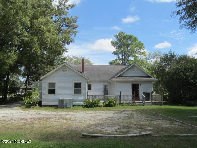 back of house with a yard and central AC unit