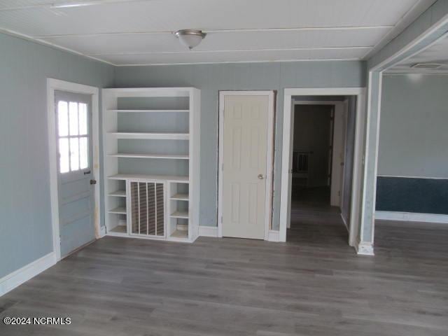 interior space with baseboards and wood finished floors