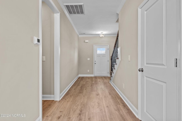 interior space featuring crown molding and light wood-type flooring