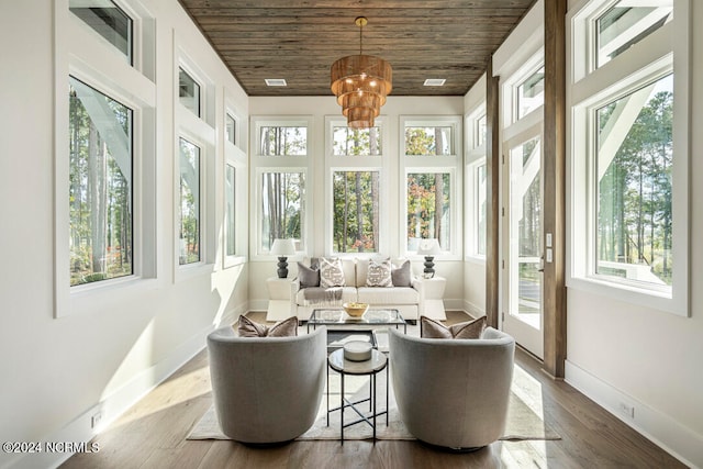 sunroom with a wealth of natural light, wood ceiling, and a chandelier