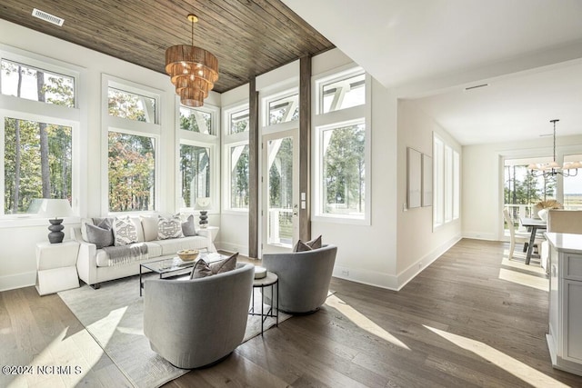 living room with a multi sided fireplace, plenty of natural light, and light hardwood / wood-style floors