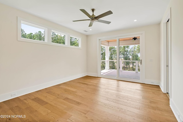 living room featuring ceiling fan with notable chandelier and hardwood / wood-style flooring