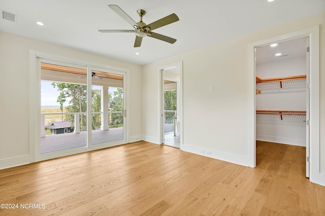 unfurnished room with ceiling fan and light wood-type flooring